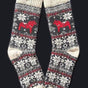 Swedish Passport Co's Socks: Red Dala Horse Black and Natural Wool Socks by Viking Knits feature a black, white, and red snowflake pattern with a Swedish Dala Horse on each sock, made from 70% wool. Displayed against a black background.