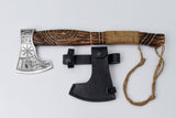The Axe: Aegir’s Wrath Utility Camping Tool, featuring a carved wooden handle and wrapped grip, is shown next to a black leather sheath on a white background.