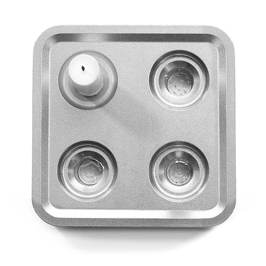 The Stumpastaken Fyran Four Candle Holder is a square, white powder-coated holder made from 100% recycled material—perfect for sustainable Swedish interior decor and holding four candles or tealights.