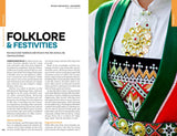 A close-up of a traditional Norwegian folk costume, adorned with intricate embroidery, vibrant hues, and ornate jewelry, displayed next to the “Lonely Planet Norway Northern Lights Safari Far North Hiking & Skiing Oslo Walking Tours Travel Guide” by Hachette Book Group—an evocative scene that captures the spellbinding allure of Norway’s folklore, festivities, and the shimmering Northern Lights celebrated in this must-have travel companion.