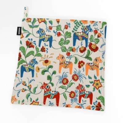 The Potholder: Leksand Mini Cream Dala Horse by Arvidssons Textil features a lively design with colorful horses, flowers, and leaves set against a crisp white background.