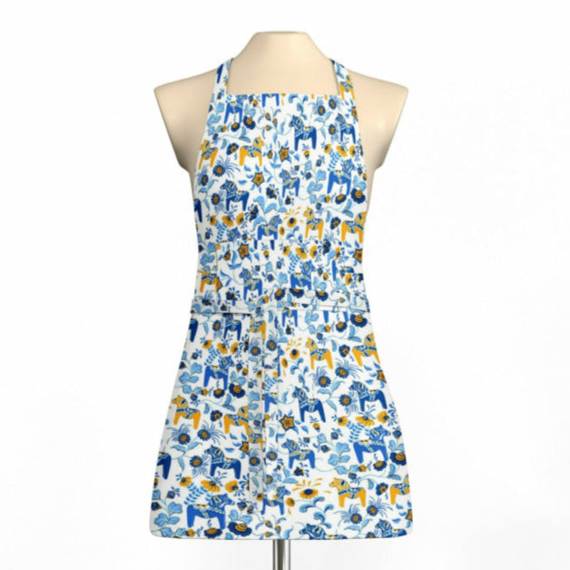 Apron on a mannequin showcasing a blue and yellow floral pattern with abstract shapes, capturing the Swedish charm of an Arvidssons Textile Leksand Mini Swedish Dala Horse design.