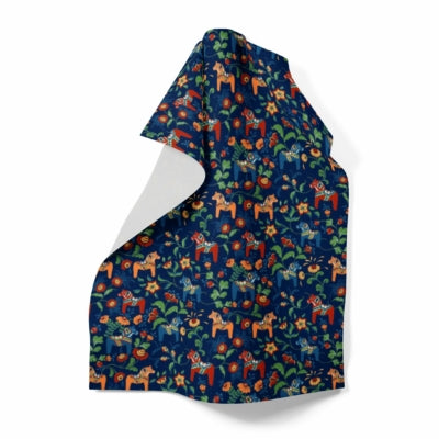 Colorful fabric featuring Swedish Dala Horses with a floral and animal pattern on dark blue. Product: Tea Towel - Leksand Mini Swedish Dala Horse Pattern, available in 4 colors.