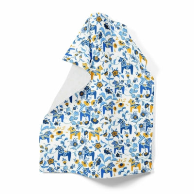 Tea towel with a blue and yellow floral pattern featuring Swedish Dala Horses, one corner folded over.