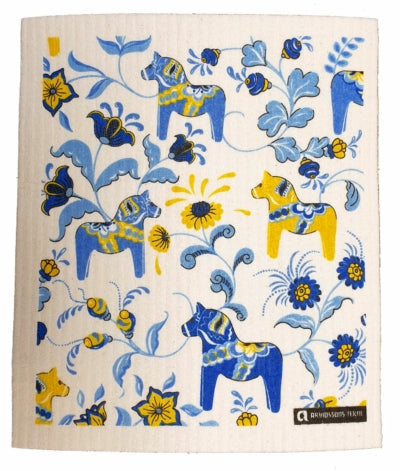 The Leksands Mini Dala Horses Dish Cloth showcases a charming design with blue and yellow horses amidst colorful flowers and leaves. Renowned for its exceptional absorbency, this dish cloth offers an eco-friendly towel solution for your kitchen.