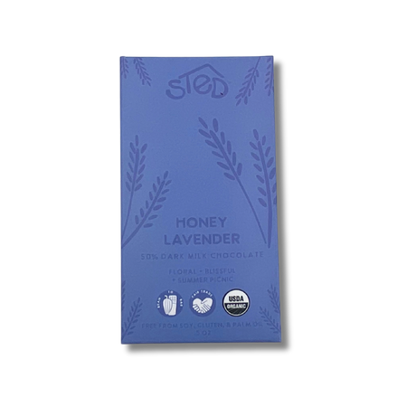 Purple chocolate wrapper with “Honey Lavender” text, floral patterns, and icons indicating organic, soy-free, gluten-free, and palm oil–free.
