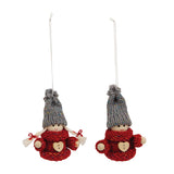 Pair of hanging Christmas gnome ornaments with red sweaters featuring heart buttons, gray knit hats, and attached string loops.