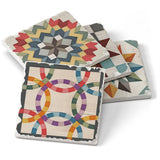 This set includes four 4" square Barn Quilt Signs stone coasters with cork backing, each featuring a colorful quilt-inspired design—perfect for adding a touch of Scandinavian style to your table.