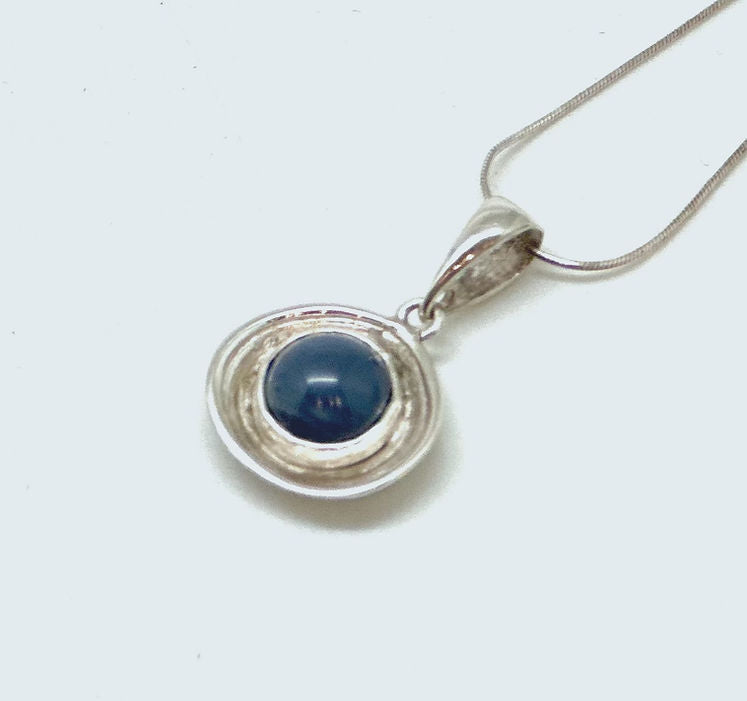 Discover the mesmerizing Eira Silver pendant adorned with a stunning Swedish Blue stone at its center.