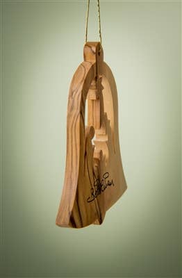 The Ornament: Bell with Nativity - 3" Christmas Tree Ornament features a nativity scene, carved from olive wood, hanging by a gold string and signed by hand on the side.