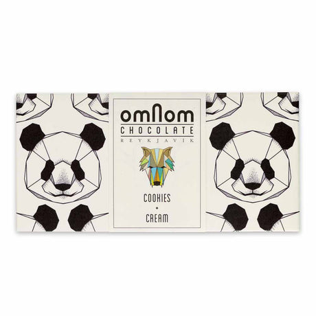 The OmNom White Chocolate with Chocolate Cookies 60g bar features geometric panda faces on its packaging and a central label, showcasing a delicious mix of white chocolate and chocolate cookies.