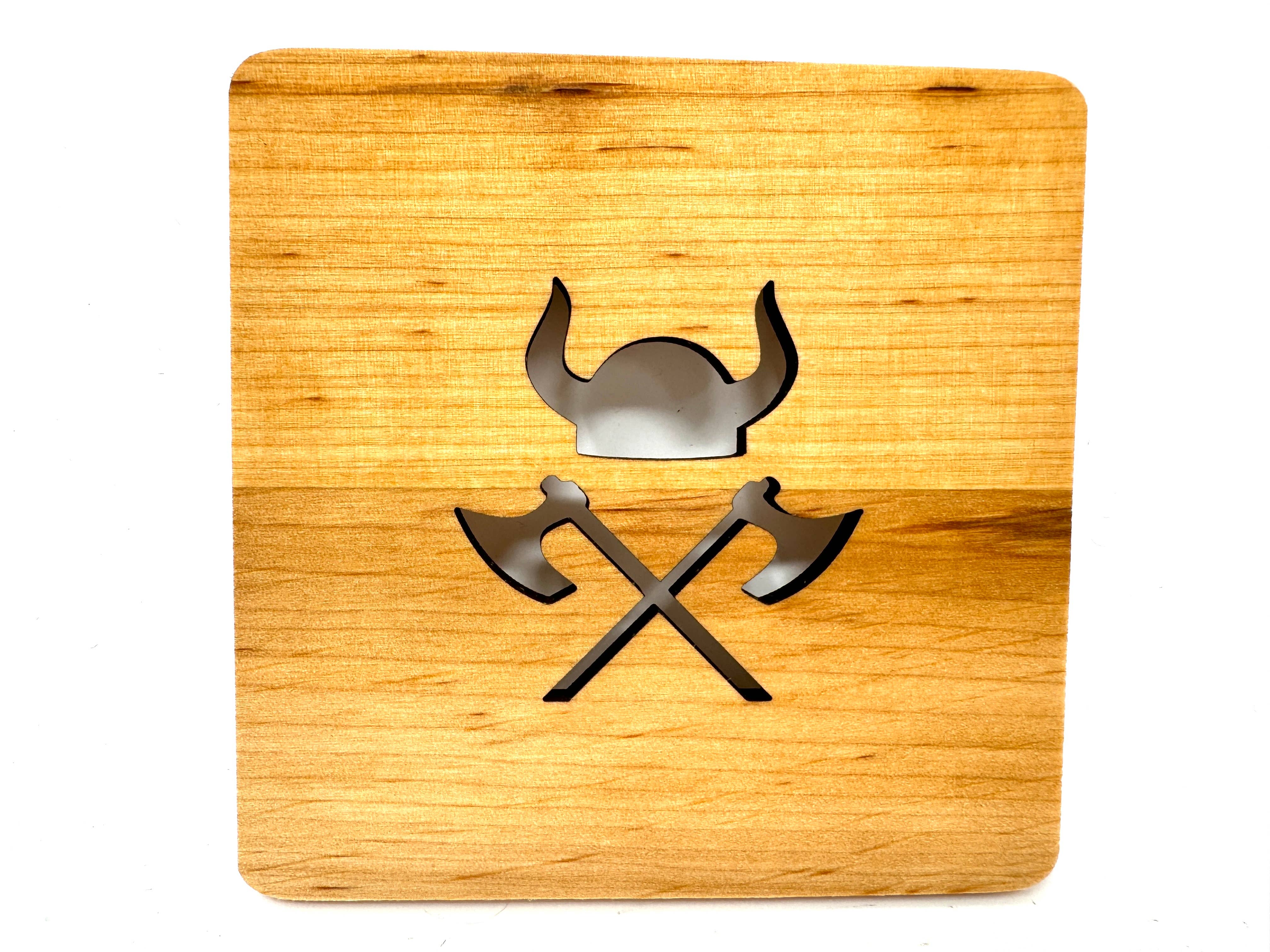 Coaster: Viking Helmet and Axes, made from handcrafted Alder wood, showcases a laser-cut design of a Viking helmet above crossed axes.