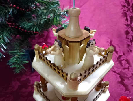 The Marketplace24 Pyramid: Christmas Pyramid Nativity Square features a manger scene on the bottom and four angels with horns on the top, standing 13" tall. Crafted in Germany, this beautiful piece makes a perfect addition to any Nativity Scene display during the holidays.
