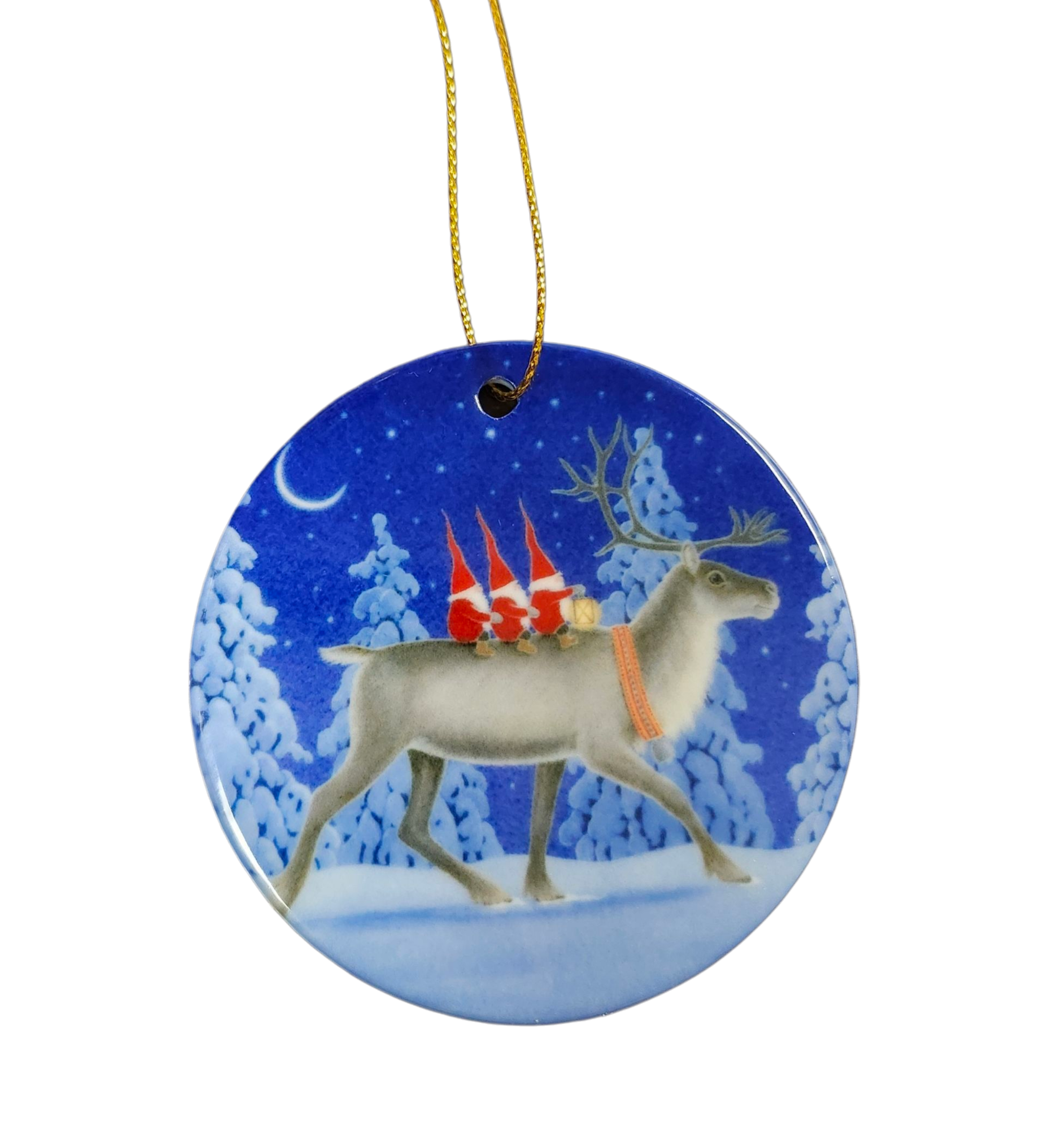 The Ornament: Tomte Riding Reindeer features Eva Melhuish’s artwork of three gnomes in red hats riding a reindeer through a snowy, moonlit pine forest, making it a charming Scandinavian addition to your holiday décor.