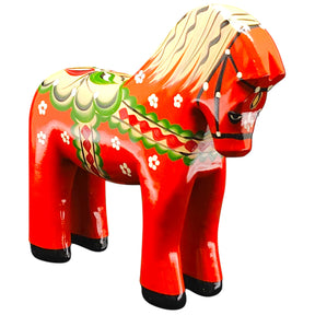 The Dala Horse: Färnäshästen Red by Nils Olsson (14 cm), a hand-carved Swedish figurine with green, white, and yellow accents, is shown on a white background.
