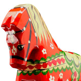 Close-up of the Dala Horse: Färnäshästen Red, a 14 cm hand-carved Swedish Dala Horse by Nils Olsson, painted red with green, white, and yellow floral patterns, shown on a white background.