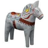 The Dala Horse: "Love Horse" Karlekshast 13cm (5") is a hand-carved wooden Swedish figurine featuring floral patterns in blue, yellow, and brown on a light gray background.