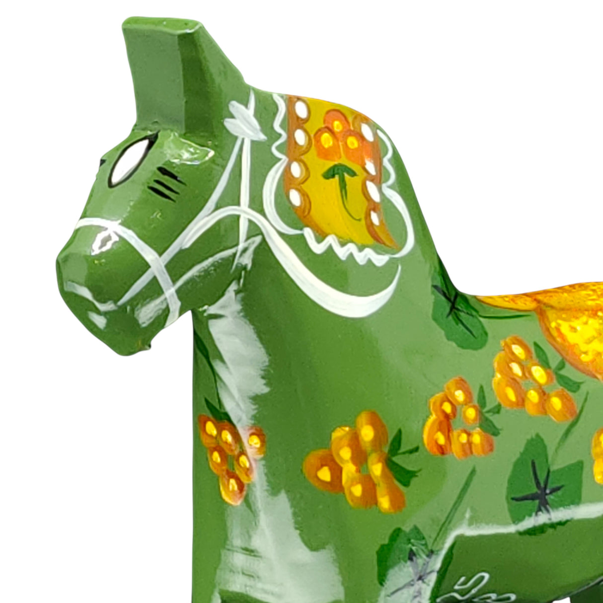 The Dala Horse: Salenhasten 13cm is a green ceramic figurine, hand-painted with yellow and orange floral patterns and white lines, highlighting Swedish craftsmanship against a plain background.