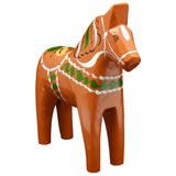 The Gammelröd Old Red Swedish Dala Horse is a 16 cm hand-carved figurine featuring traditional Scandinavian craftsmanship with green, white, and yellow decorative patterns.