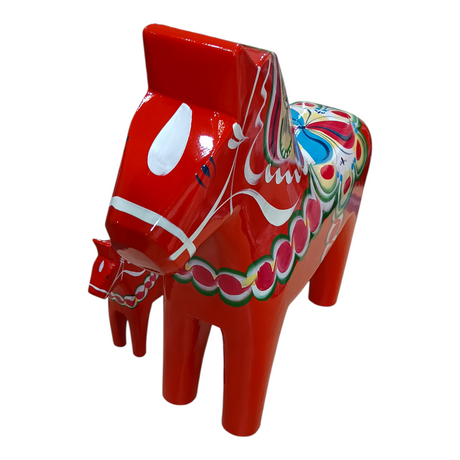 Two red Swedish Dala Horse figurines, handcrafted in Sweden and featuring colorful Nordic folk art patterns, stand side by side on a white background, showcasing classic Dala Horse design.