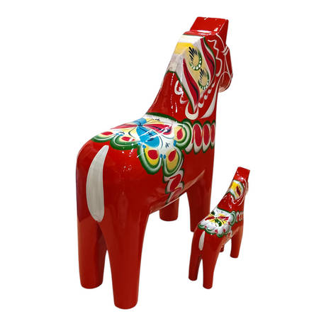 Two red Swedish Dala Horse figurines—one large, one small—handcrafted in Sweden, display Nordic Folk Art with vibrant patterns. The Dala Horse: Red Swedish Dala Horse Figurine (Multiple Sizes) stands out against a white background.