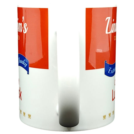 White ceramic 11oz coffee mug featuring a red and white design with "Lindstrom's Cream of Lutefisk Soup" text—an ideal Swedish-American souvenir from Lindstrom, Minnesota. Perfect for enjoying your favorite beverage!.