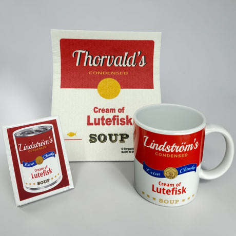 The Flash Bundle: Cream of Lutefisk Bundle with Free Magnet features a mug, dish towel, and magnet with a Thorvalds Cream of Lutefisk Soup design—fun Swedish-American souvenirs shown on a white background.