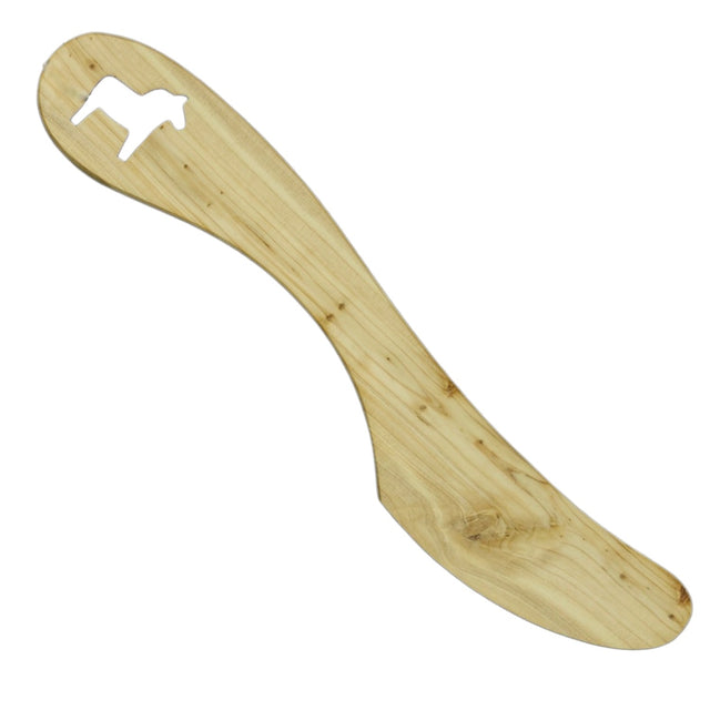 A wooden spreader from the Bundle: Dala Horse Kitchen Accessories, crafted from alder wood with a charming dog cutout—perfect for Scandinavian decor and lovers of unique kitchen tools.