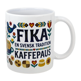The Mug: Swedish Fika Traditions Wraparound Ceramic Mug (11 oz) by Swedish Gift Store features white ceramic with folk art—flowers, hearts, a blue bird, pastries—and “Fika En Svensk Tradition KaffePaus.” Perfect for Swedish coffee breaks.