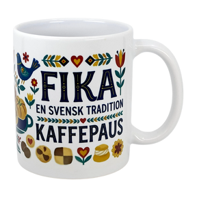 The Mug: Swedish Fika Traditions Wraparound Ceramic Mug (11 oz) by Swedish Gift Store features white ceramic with folk art—flowers, hearts, a blue bird, pastries—and “Fika En Svensk Tradition KaffePaus.” Perfect for Swedish coffee breaks.