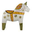 White hand-carved Dala horse with yellow, red, and green patterns, standing on all four legs and facing right.