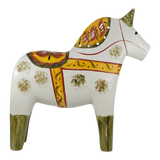 White hand-carved Dala horse with yellow, red, and green patterns, standing on all four legs and facing right.