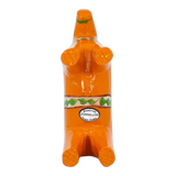 Orange Swedish Dala horse figurine made of pine wood shown on its back, decorated with green and white designs and a visible label on one side.