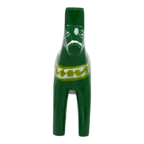 Green Dala horse figurine with white and yellow patterns on its body, displayed against a white background.