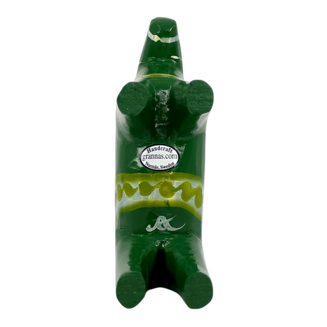 Green Swedish Dala Horse figurine with yellow painted details and a small sticker on its chest reading Handcraft grannas.com, Nusnäs, Sweden.