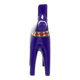 Front view of a small purple Dala horse made of wood with green and red decorative patterns around its neck.