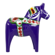 Purple Swedish Dala horse figurine with green, red, and white painted decorations, made of wood, displayed on a white background.