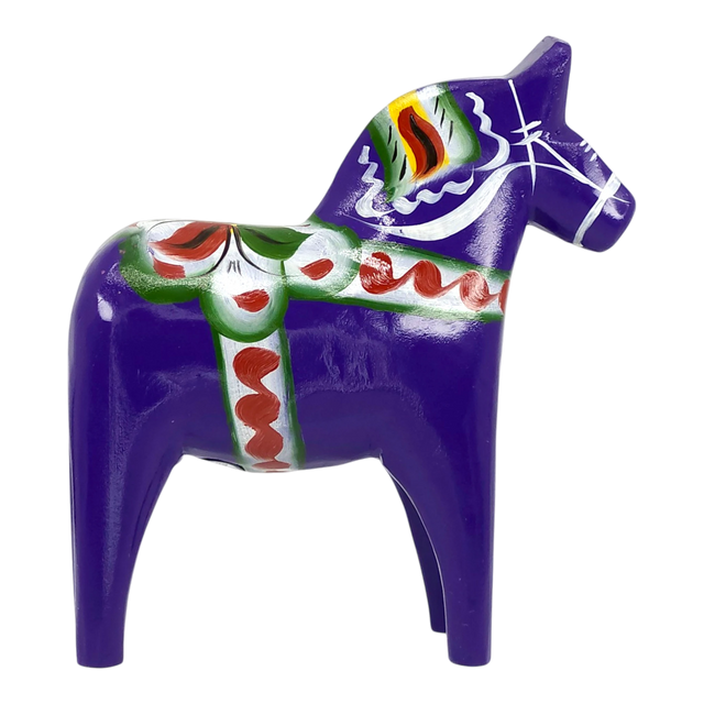 Purple Swedish Dala horse figurine with green, red, and white painted decorations, made of wood, displayed on a white background.