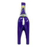 Purple Swedish Dala horse figurine made of pine wood, shown from the back with painted green, yellow, and white patterns on a plain white background.