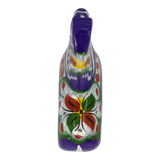 Purple Swedish Dala horse carved from wood, shown against a purple background with red, green, yellow, and white floral patterns painted on the front.