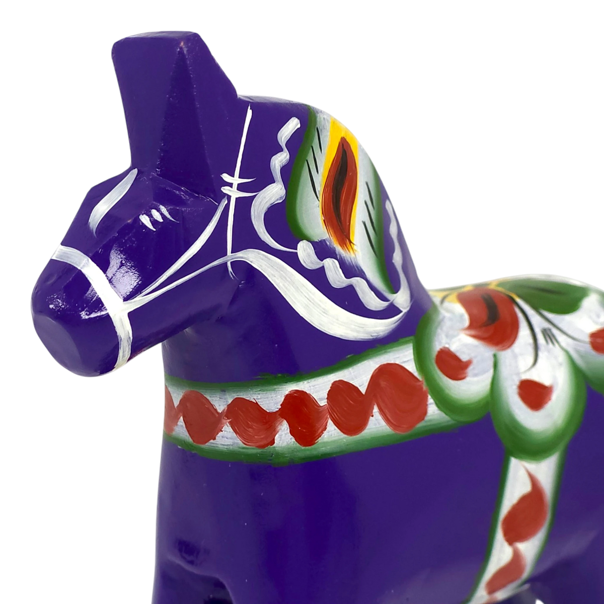 Purple Swedish Dala horse made of wood with hand-painted green, red, white, and yellow patterns on its body, shown close up against a plain white background.
