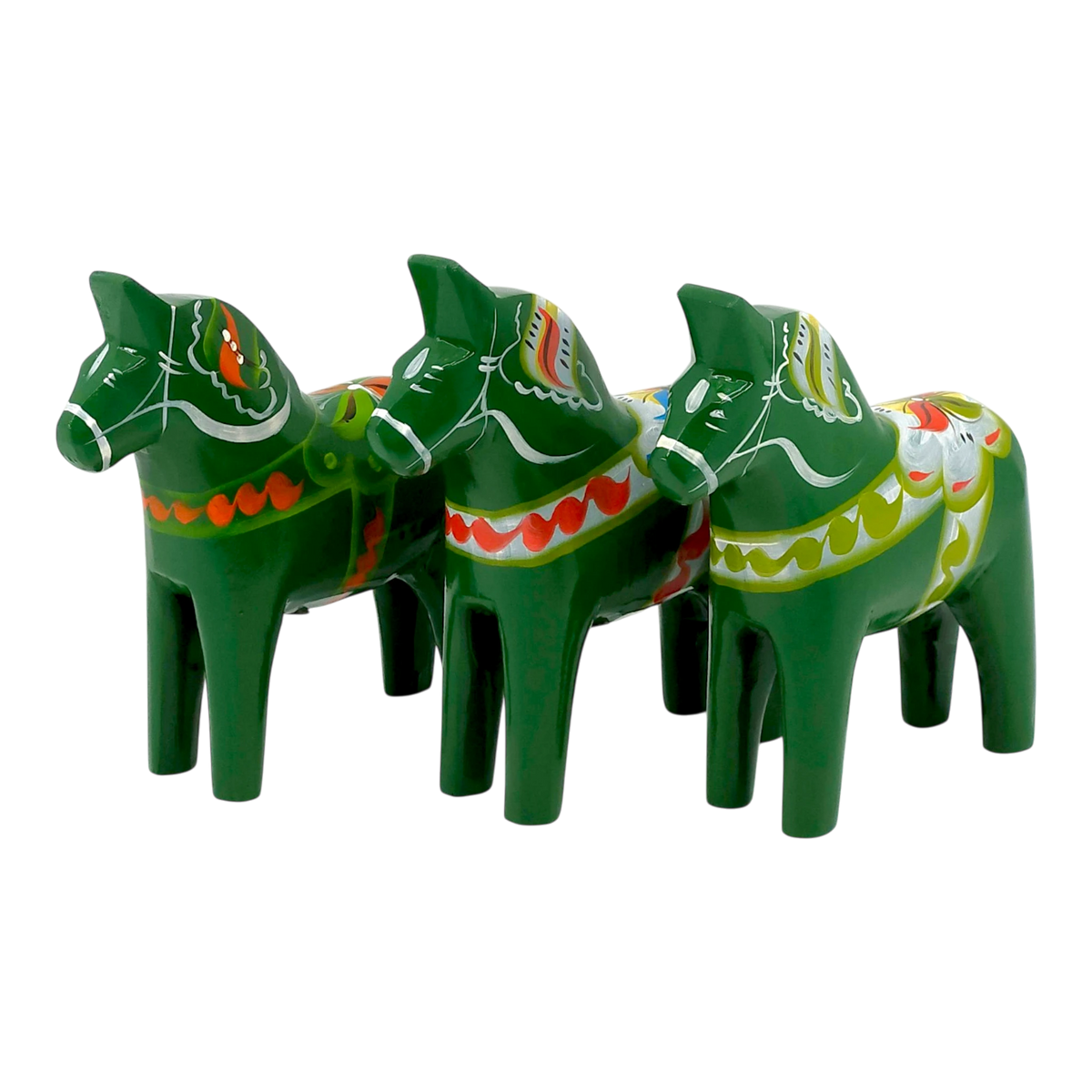 Three green Swedish Dala Horse figurines with colorful painted patterns, standing in a row and facing left on a plain white background.