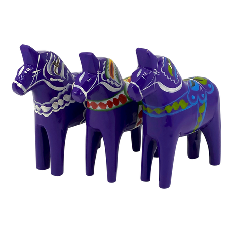 Three purple Dala Horse figurines made of Swedish pine wood, each hand-painted with colorful Scandinavian patterns, displayed side by side.