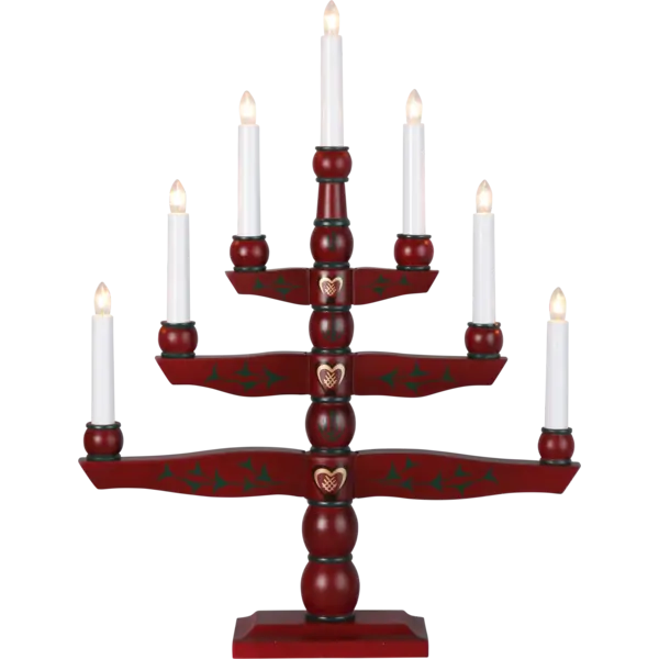 The Star Trading Candelabra, titled "Candlestick Tradition," is a red, electric 7-light piece that exudes an Advent ambiance with its seven white candles. It is adorned with intricate floral designs and heart motifs, seamlessly blending traditional charm with elegance.