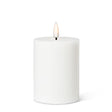 The 4" LED Pillar Candle in white features a cylindrical shape with a realistic LED flame that flickers gently at the top, providing a soothing glow for up to 150 hours.