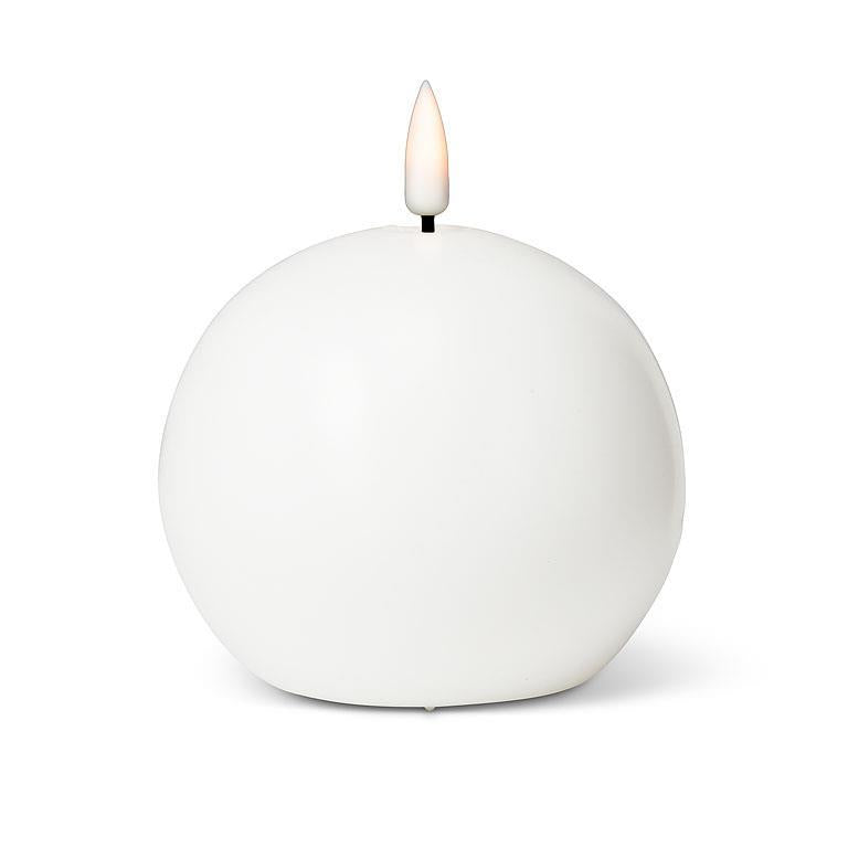 The Candle: 4" LED Ball Candle, White offers a warm white glow with a lifelike LED flame, giving the appearance of a spherical white candle with a gently flickering flame on top.