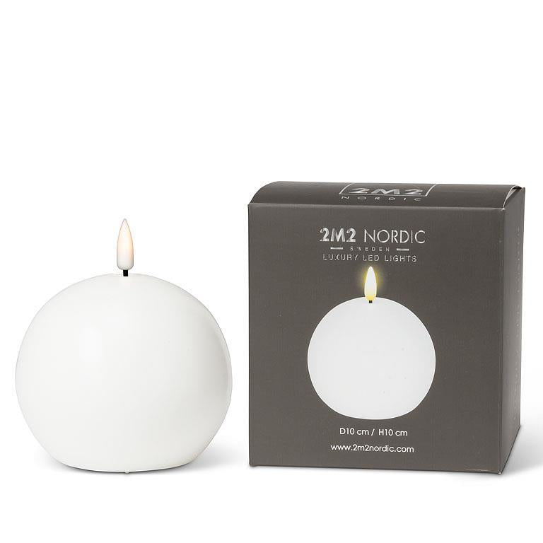 A 4" LED ball candle in white sits elegantly beside a matching box labeled 2M2 Nordic Luxury LED Lights, featuring a warm white glow with a realistic LED flame.