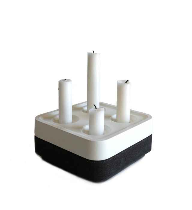 The Stumpastaken Fyran Four Candle Holder is a square, white powder-coated holder crafted from 100% recycled material—an elegant embodiment of sustainable interior decor and timeless Swedish design.