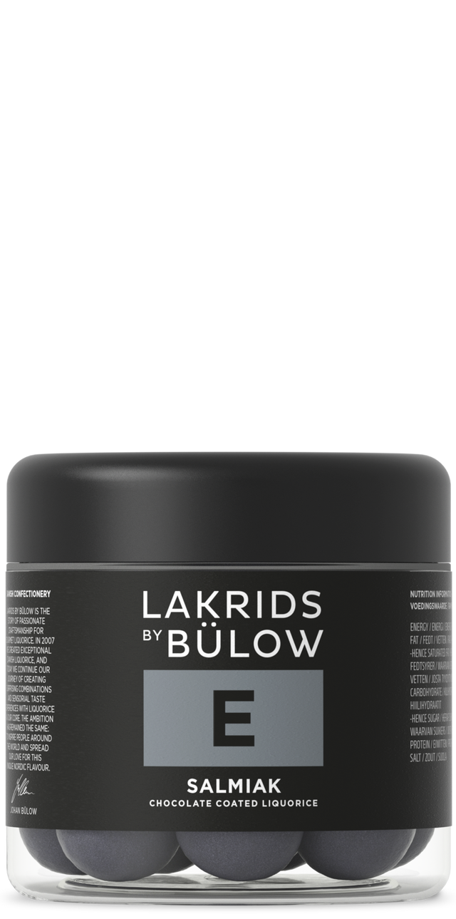 A jar with a black lid and black label displaying “Lakrids by Bülow E Salmiak,” containing round Nordic candy pieces.