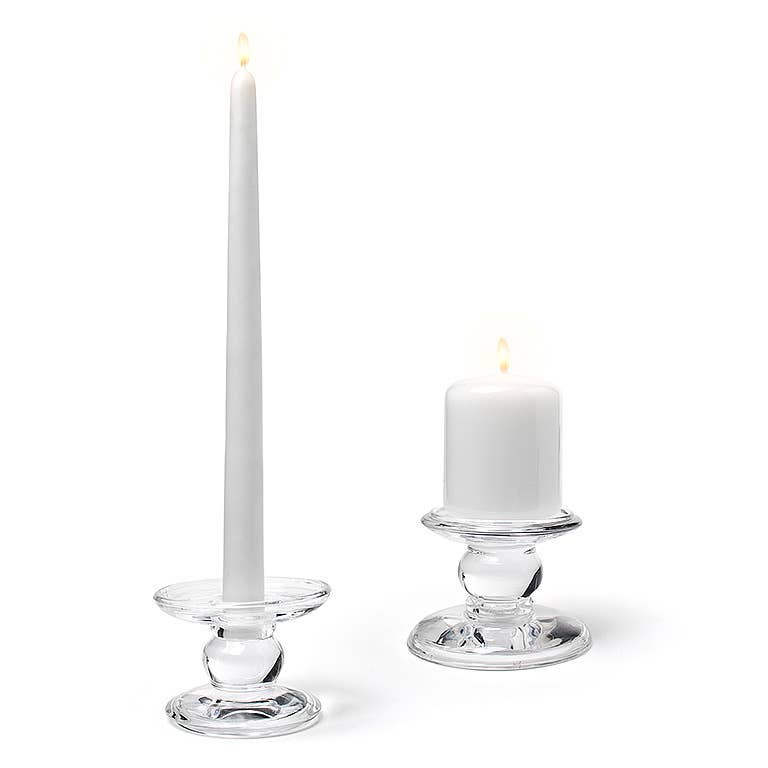A lit white taper candle and a lit white pillar candle, each in a Small Reversible Candle Holder-3.5"L, are displayed against a plain white background.